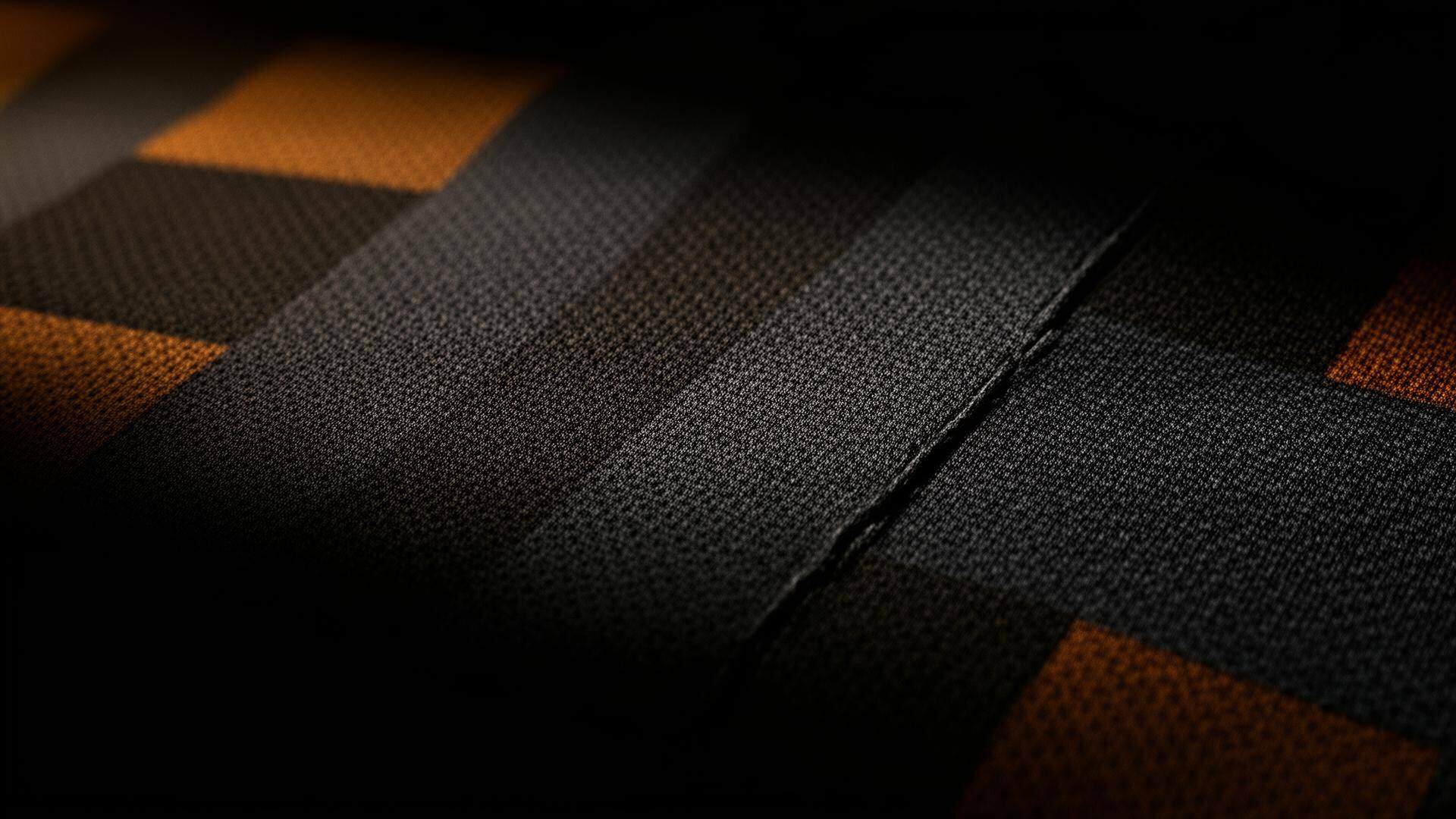 Macro close-up of woven football jersey fabric with subtle color blocks